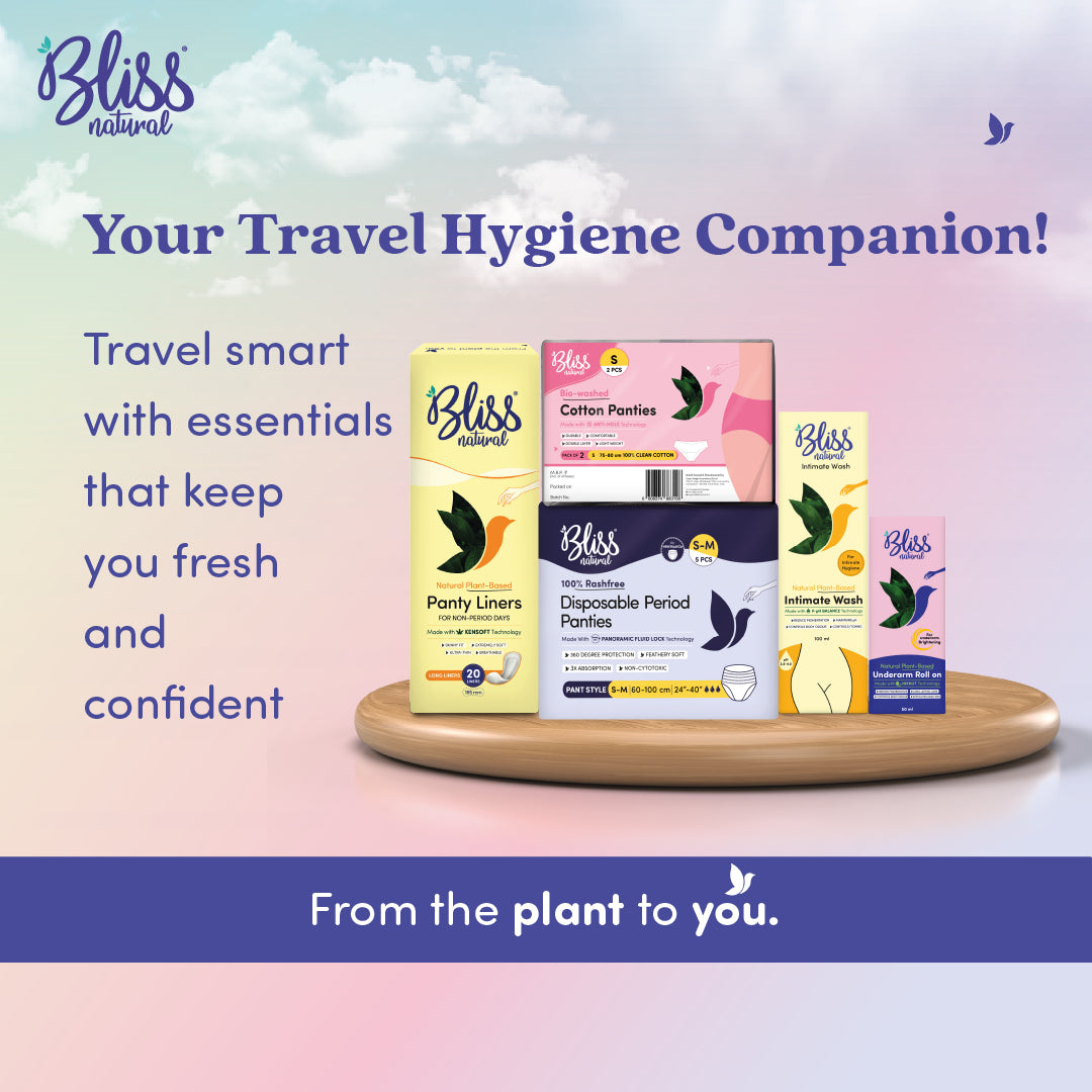 Bliss natural travel hygiene products on a wooden tray with a scenic background