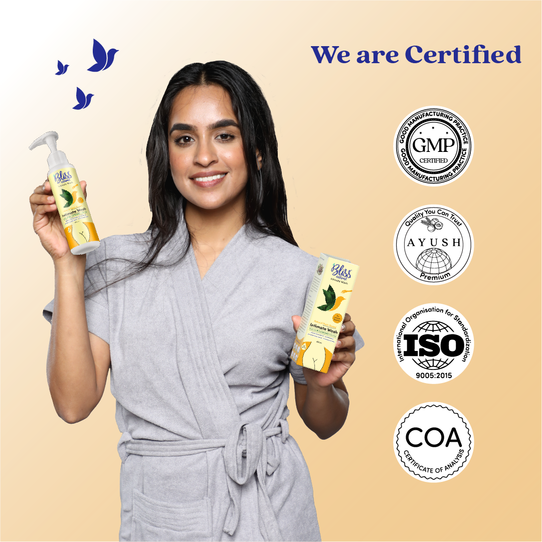 Woman holding a bottle of Bliss Intimate wash with certification logos on a beige background